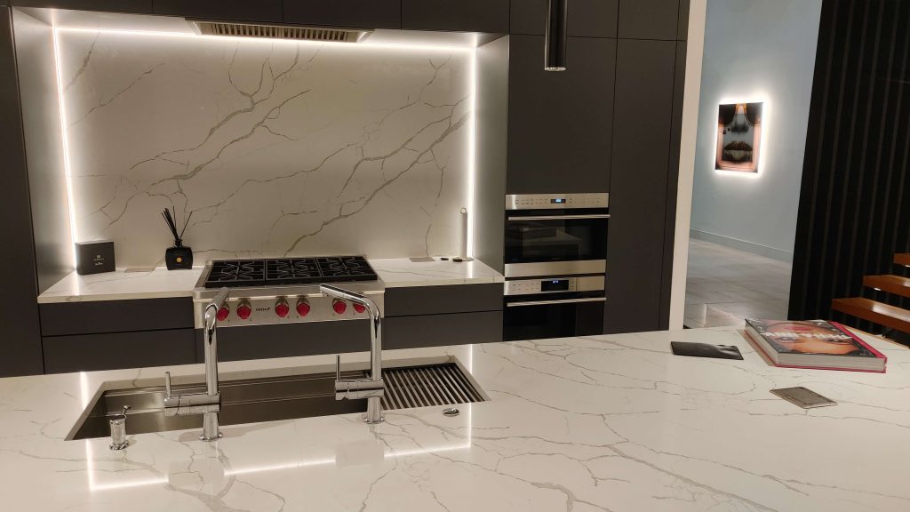 Modern kitchen with white counter lighting and marble countertops
