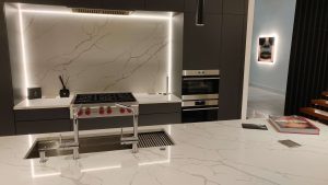 Modern kitchen with white counter lighting and marble countertops